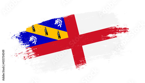 Flag of Herm country on brush paint stroke trail view. Elegant texture of national country flag