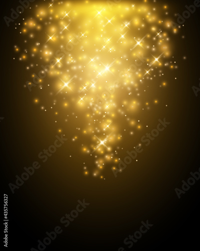 Golden particles falling down on dark background
