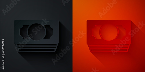 Paper cut Stacks paper money cash icon isolated on black and red background. Money banknotes stacks. Bill currency. Paper art style. Vector