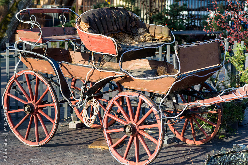Fototapeta premium Old Carriage outdoor cafe evening sunset outdoor town.The carriage is lined with garland.