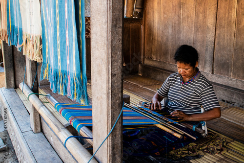 The activity of manually weaving traditional cloth at Bena Village, Flores, East Nusa Tenggara, Indonesia  photo