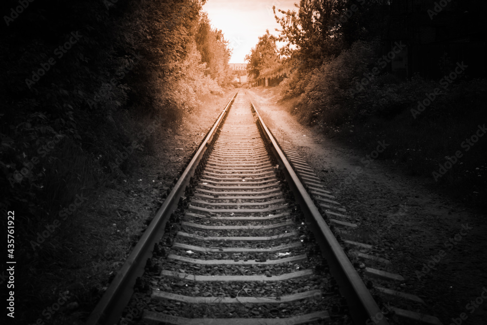 light at the end of the tunnel. the railway goes into the distance. black and white frame light at the end of the tunnel. the railway goes into the distance. black and white frame
