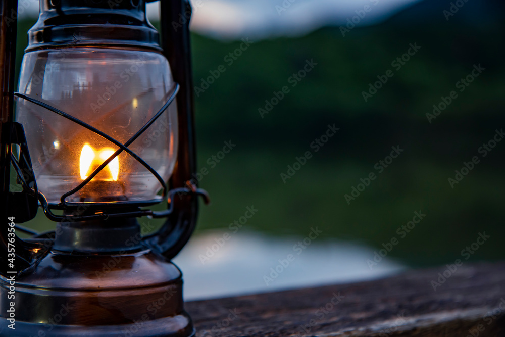 Light an oil lantern by the lake.
Light an oil lantern by the lake.
