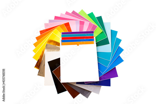 Twisted pile of colorful 12x12 sheets of adhesive paper with box isolated over the white background. Mockup. photo