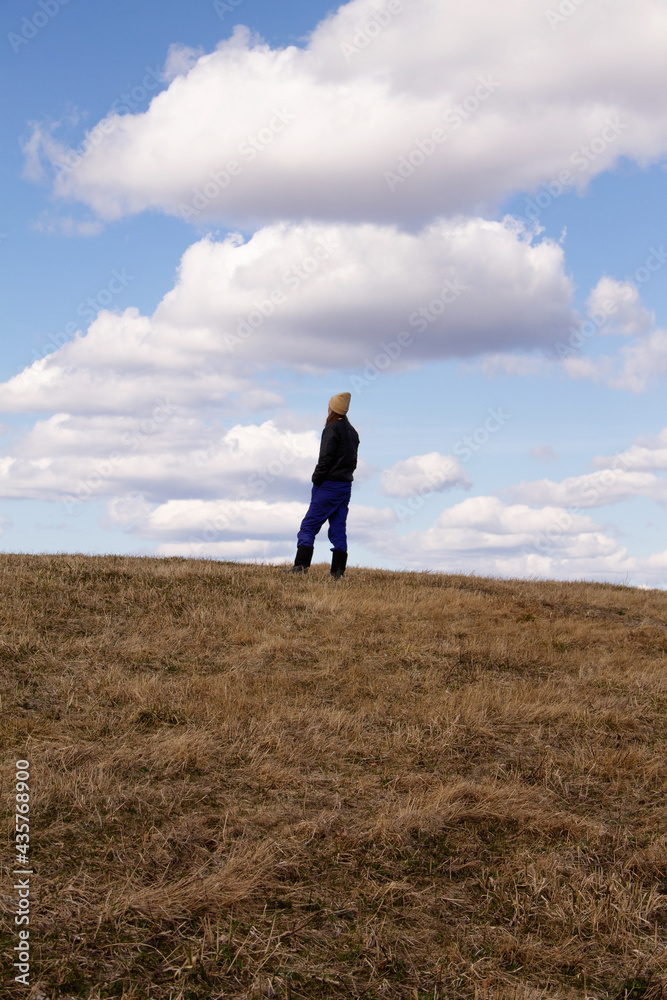 natural landscape a lonely man builds against the sky with clouds in early spring natural landscape a lonely man builds against the sky with clouds in early spring