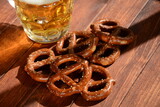 Hard Pretzels or Salted pretzels snack for party on rustic wooden table with glass of beer