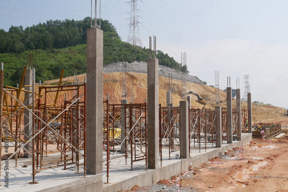 SEREMBAN, MALAYSIA -AUGUST 1, 2020: The concrete pillar structure is under construction at the construction site. The mold uses timber formwork and is temporarily supported with scaffolding. SEREMBAN, MALAYSIA -AUGUST 1, 2020: The concrete pillar structure is under construction at the construction site. The mold uses timber formwork and is temporarily supported with scaffolding.