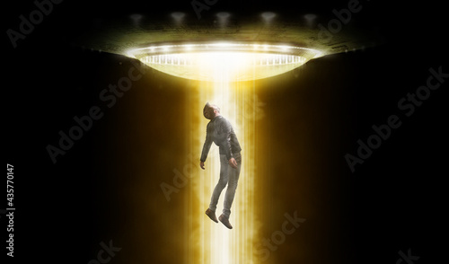 Man being abducted by UFO photo