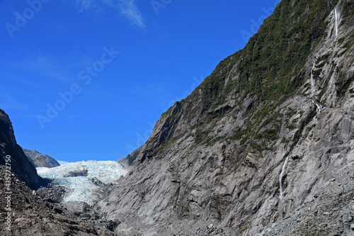 spectacular waterfalls and the terminus of the franz joseph glacier as seen from the franz joseph glacier walk overlook on the west coast of the south island of new zealand 