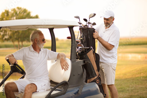 Two senior men golfers on court. Men preparing for golf.