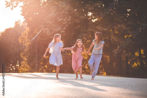  Three little girls spending time together in the park.