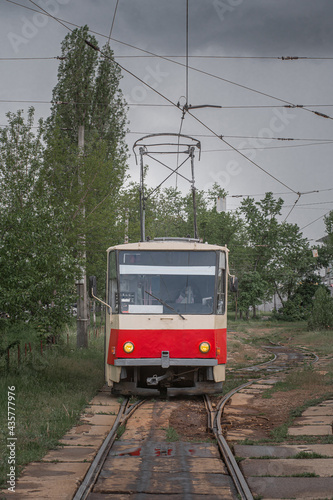 Old empty red Tatra T5 tram in cloudy day. View from the side.