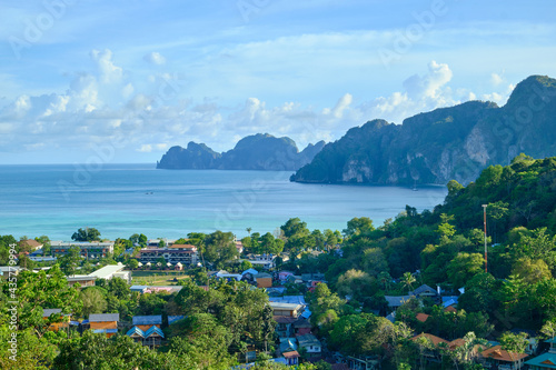 panoramic view from high angle viewpoint on Phi Phi Island, beautiful tourism places like paradise Overlooking house Buildings from hotels and resorts to the seacoast and blue sky.
