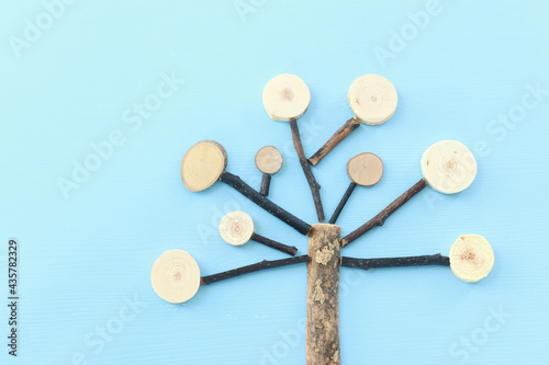 Image of wooden growing family tree on blue background 