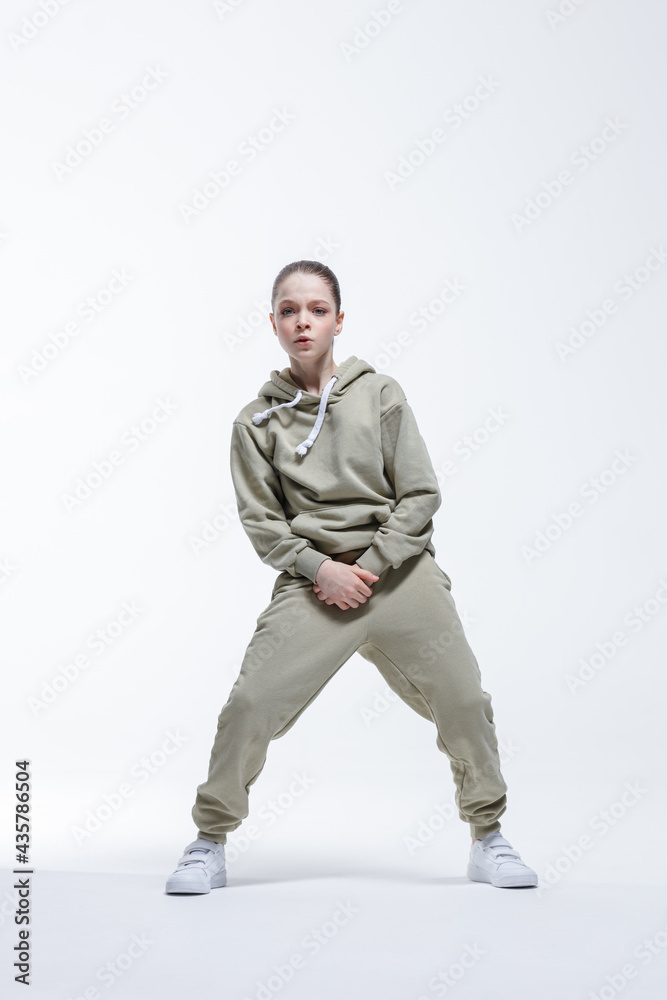Young beautiful cool looking girl posing in studio Young beautiful cool looking girl posing in studio