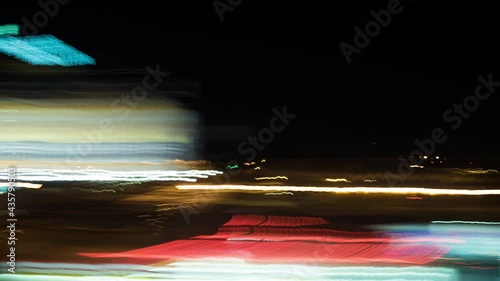 Light streak ride through a city on a monorail