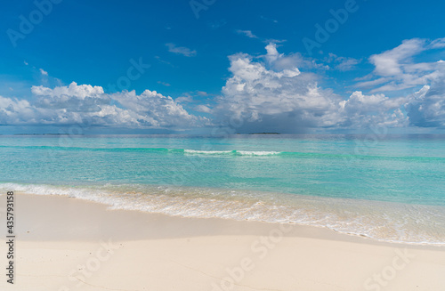 Paradise white sand beach and turquoise water in nice summer day, Gulhi Island, Maldives