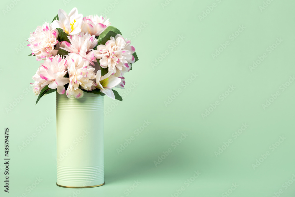Flowers in a metal can with copy space