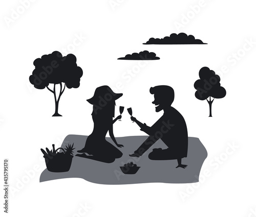 silhouette of a couple on a picnic in the park