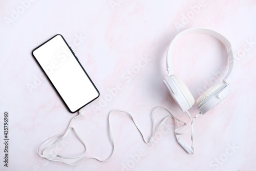 Smartphone with headphones connect on white background