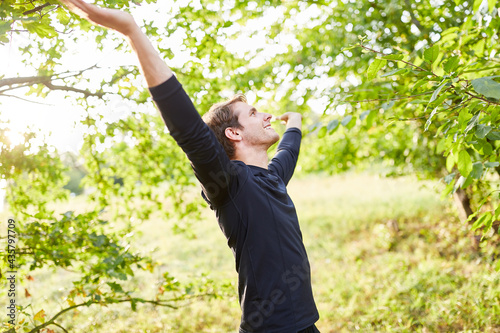 Young man doing a breathing exercise in the fresh air