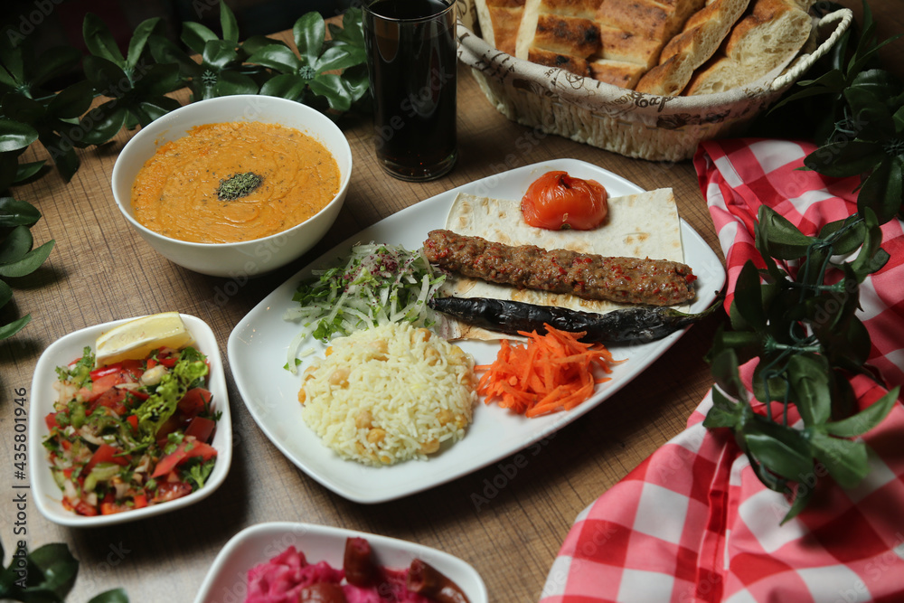 Turkish Adana Kebab with fresh vegetables on flatbread Top view, flat lay Turkish Adana Kebab with fresh vegetables on flatbread Top view, flat lay