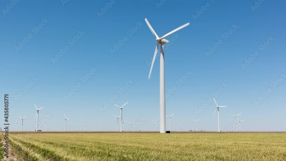 Timelapse of wind turbines in a grassy field Timelapse of wind turbines in a grassy field