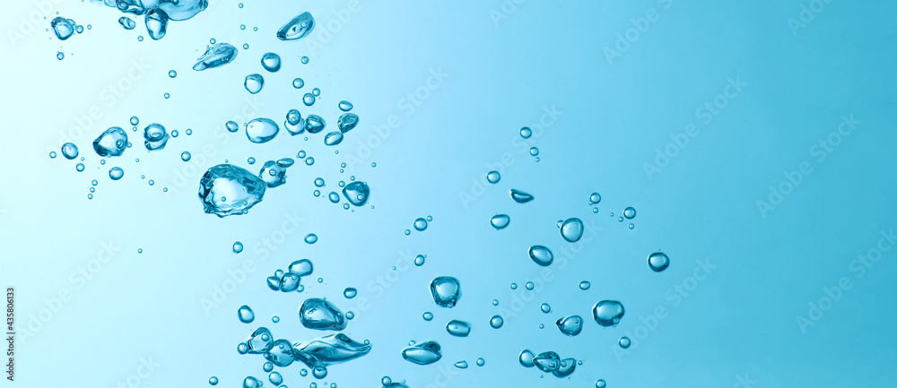 Blue bubbles under water flowing up to the surface in nature. Blue background with copy space Blue bubbles under water flowing up to the surface in nature. Blue background with copy space
