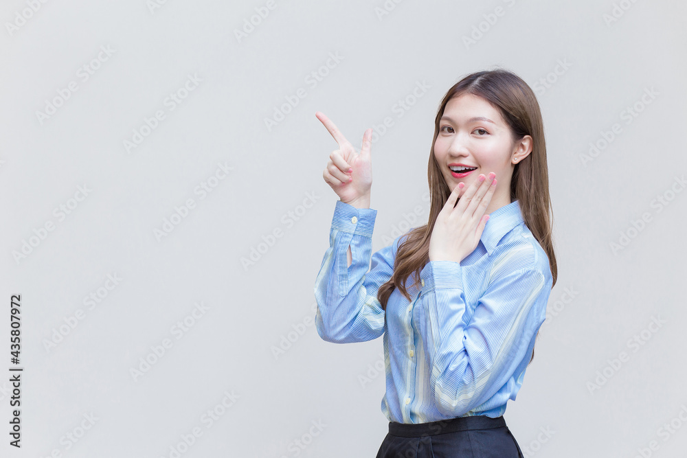 Beautiful business woman who has long hair Asian with a blue shirt smiles present something on a white background. Beautiful business woman who has long hair Asian with a blue shirt smiles present something on a white background.