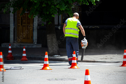 Worker applies road markings, markings for cars