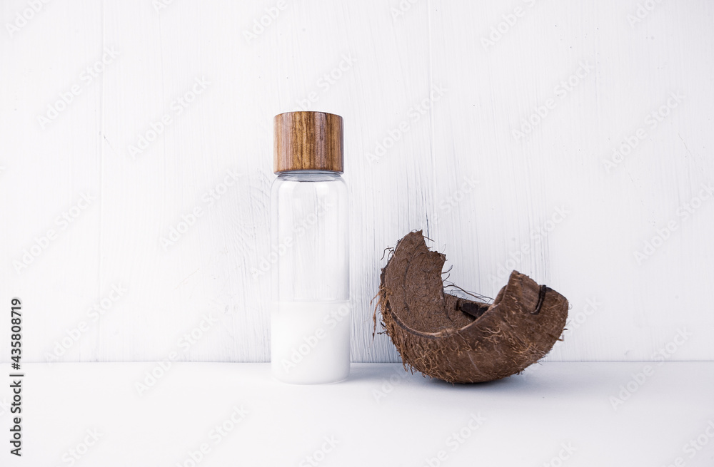 Coconut oil in a coconut shell on a white background