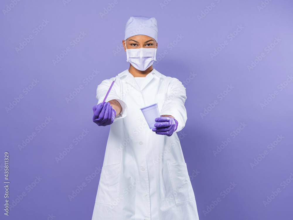 cute and young nurse holding a plastic cup cute and young nurse holding a plastic cup