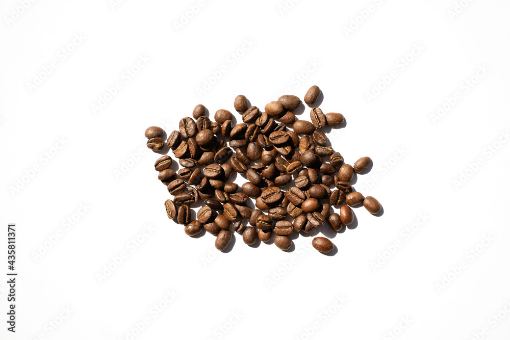 Isolated roasted coffee beans in harsh light. White background top view Isolated roasted coffee beans in harsh light. White background top view