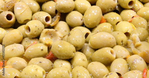 green olives in brine for sale in the street market stalls of southern Italy