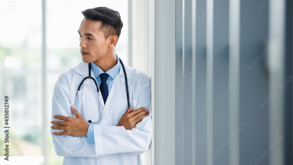 Content male medic looking at camera in hospital Content male medic looking at camera in hospital