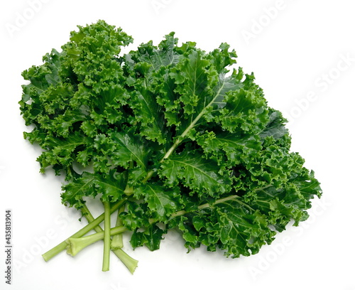 organic green kale leaves isolated on white background.