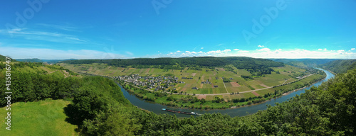 Panoramic  aerial view of the Moselle Valley and the river Moselle with forests en vineyards and the village Burg under a blue sky in the afternoon. Bernkastel-Wittlich  Germany. Copy space included.