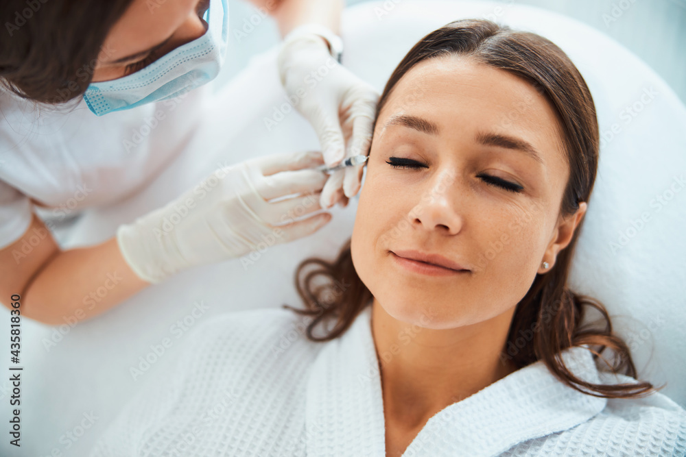 Female patient getting a subcutaneous injection for wrinkles Female patient getting a subcutaneous injection for wrinkles