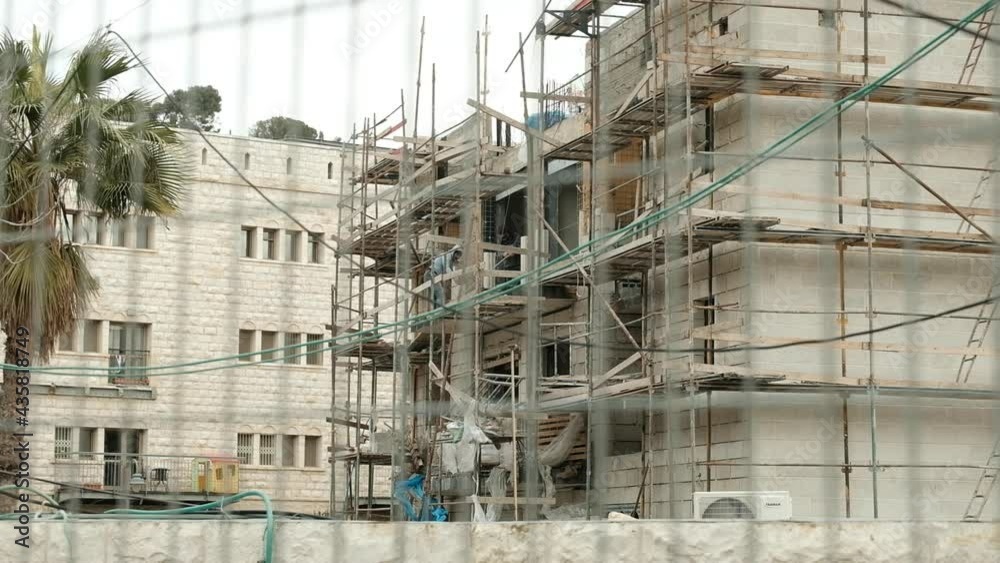 A large construction site of a Jewish residential project within the Sheikh Jarrah neighborhood, Palestinian workers for Jewish settlers, a middle Eastern paradox, Jerusalem, Israel. A large construction site of a Jewish residential project within the Sheikh Jarrah neighborhood, Palestinian workers for Jewish settlers, a middle Eastern paradox, Jerusalem, Israel.