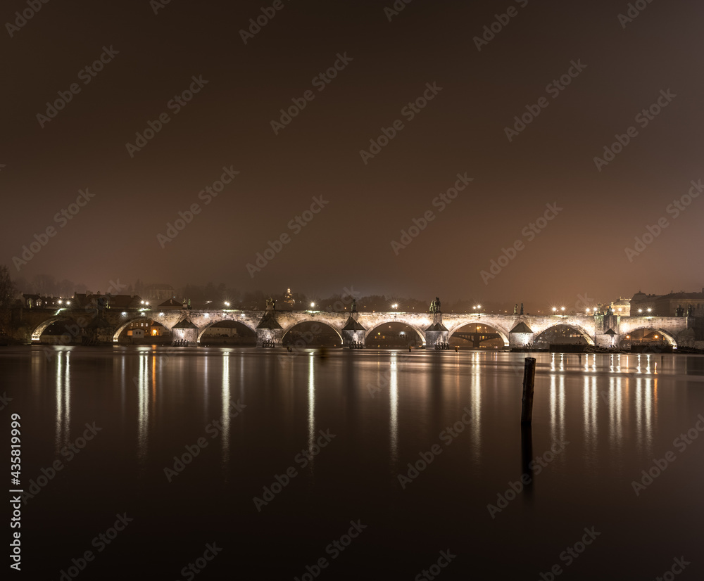 Night shot of Charles Bridge - Karluv most - over river Vltava in Prague; taken from Strelecky ostrov, long exposure