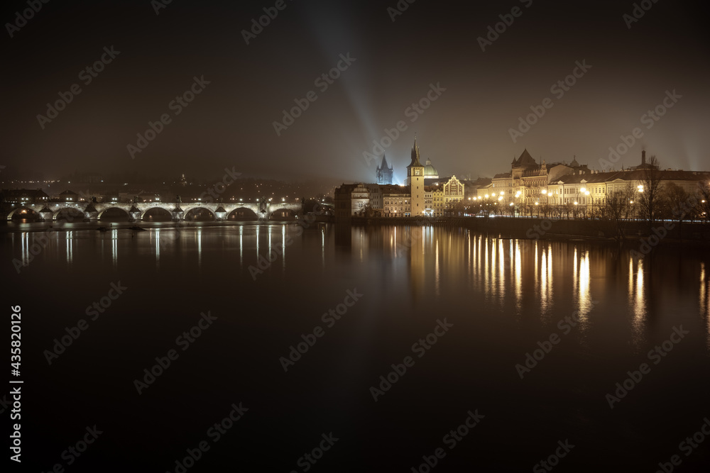 Night shot of Charles Bridge - Karluv most - over river Vltava in Prague; taken from Strelecky ostrov, long exposure