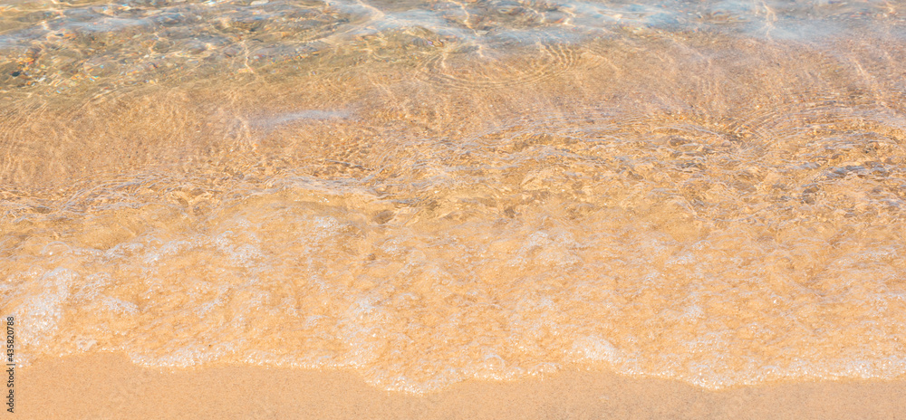 Soft sea wave on sand beach. Summer background. Concept of travel, vocation, relax Soft sea wave on sand beach. Summer background. Concept of travel, vocation, relax