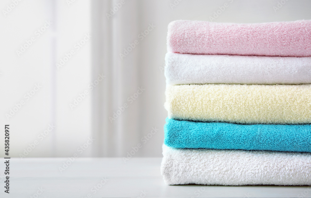 Stack of colorful terry towels empty space design. Colorful laundry.Household. Stack of colorful terry towels empty space design. Colorful laundry.Household.