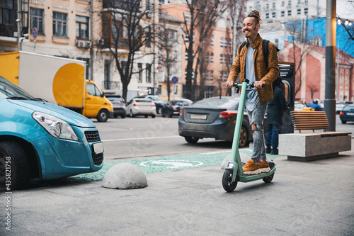 Happy person enjoying using ecofriendly personal vehicle in the city