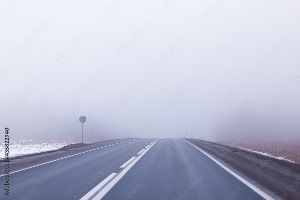 Fototapeta premium abstract winter road fog snow, landscape view in november transport