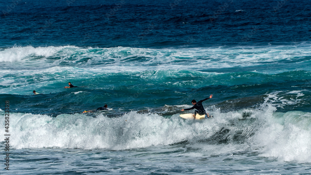 surfing on the beach of la cicer in Las Plamas de Gran Canaria