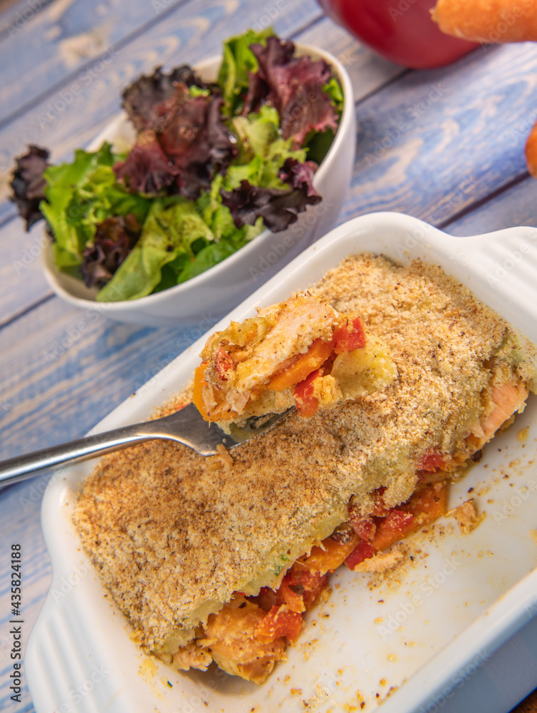 Salmon Parmentier recipe with hazelnuts, young salad leaves. High quality photo