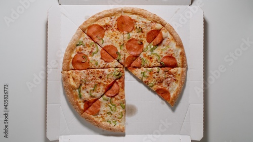 TOP VIEW: Pizza Without one Piece in The Box photo