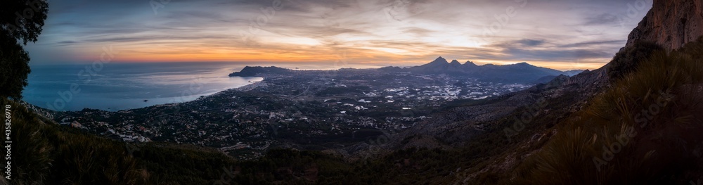 Beautiful panorama of the sunset from the mountain. Privileged views of Altea, Benidorm and Alicante from the top of a mountain. Sunset on the mountain, while the sun illuminates the Alicante coast