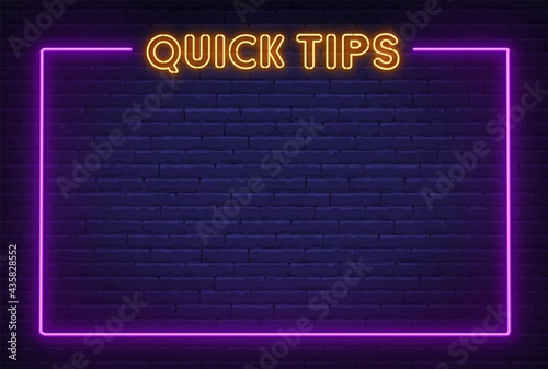 Quick Tips neon sign with frame on brick wall background.